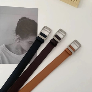 Three minimalist leather belts in black, dark brown, and tan with matte silver buckles
