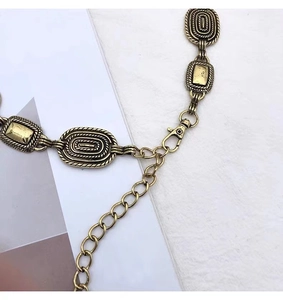 Detailed close-up of vintage engraved silver waist chain with adjustable lobster clasp