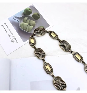 Detail of vintage carved metal chain with antique bronze finish and embossed patterns