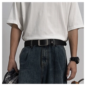 Minimalist black leather belt with silver square buckle shown on washed blue jeans