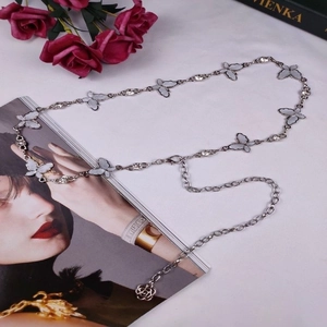 Detailed macro view of silver butterfly waist chain with rose pendant and sparkling crystals