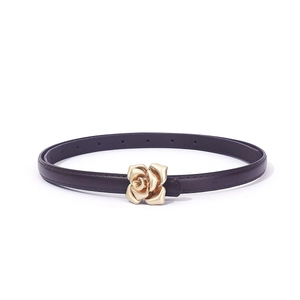 Détail d'une ceinture en cuir vintage avec boucle métallique en forme de rose dorée