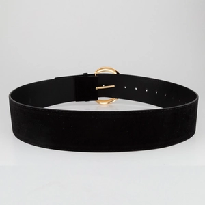 Detail of black suede wide belt with polished gold oval buckle and neat edge stitching