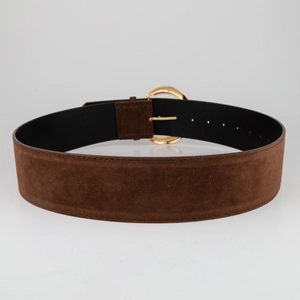 Macro detail of wide brown suede belt with premium gold round buckle and neat stitching