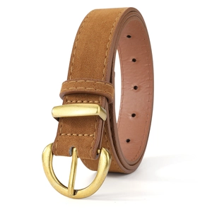 Detail of dark brown faux suede belt with vintage gold horseshoe buckle and fine stitching