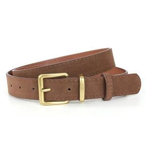 Macro detail of brown faux suede vintage belt with gold buckle and fine stitching