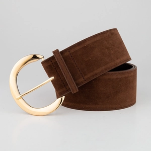 Detail of dark brown suede wide belt featuring a large polished gold crescent buckle