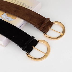Detailed close-up of retro suede waist belts in black and brown with gold D-ring buckles