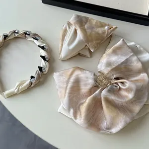 French style hair accessory set with marble pattern headband and satin bow shark clip