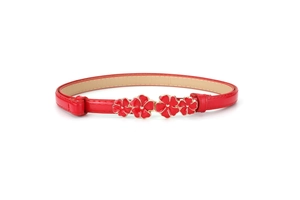 Detail of red faux leather belt featuring a golden metal buckle with enamel flowers