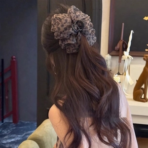 Leopard print seersucker hair claw clip styled on long curly hair for women