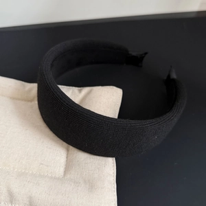 Thick black knitted sponge headband with wide edge design for a minimalist fashion look