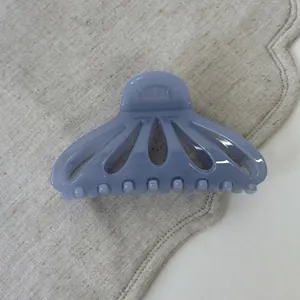 Macro shot of a lavender translucent fan-shaped hair claw clip with cutout design