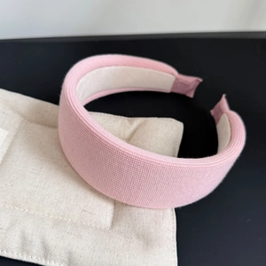 Macro detail of pink thickened knitted headband with anti-slip inner lining texture