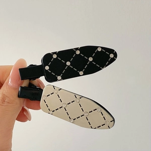 Elegant quilted hair clips in black and cream white with embedded crystal rhinestones