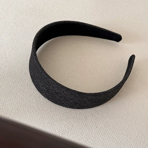 Detailed view of wide denim fabric headband with diagonal twill texture for women