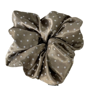 Golden brown satin hair scrunchie with white polka dot pattern and elastic design