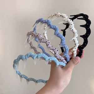 Polka dot wavy headband with inner comb teeth in assorted colors for hair styling