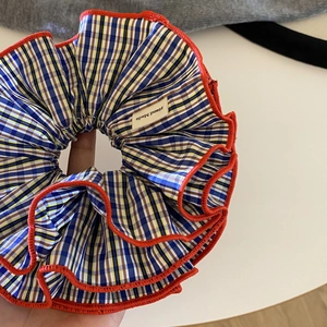 Retro blue and yellow checkered scrunchie with red wavy edge and handmade label