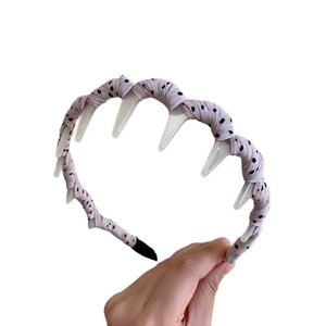 Polka dot fabric headband with integrated clear hair clips for volume and styling