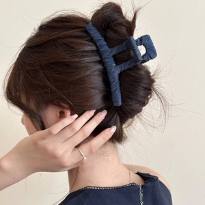 Deep blue denim shark hair claw clip for women shown on hair in a stylish back view