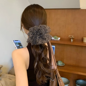 Leopard print mesh hair scrunchie shown on a ponytail with a retro aesthetic style