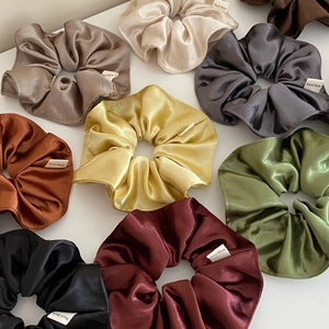 Handmade silk satin scrunchies in multiple colors like olive green and burgundy