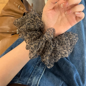 Leopard print mesh hair scrunchie with fluffy oversized design worn on model wrist