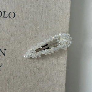 Close-up of sparkling heart-shaped crystal BB hair clip with silver metal base
