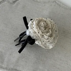 French style floral hair claw with white polka dot chiffon petals and black velvet bow