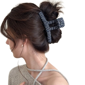 Vintage denim hair claw clip with white thread wrap on model hair bun