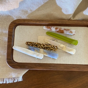 French vintage acetate hair clips set in marble and leopard patterns on wooden tray