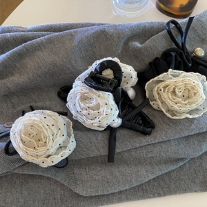 Korean style polka dot rose hair claws and ties with pearls on a soft grey sweater