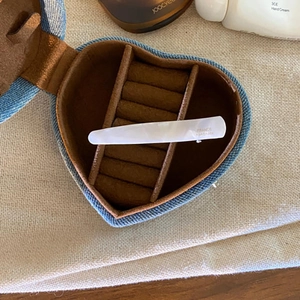 Detail of handmade acetate hair clip in heart denim gift box with gold lettering