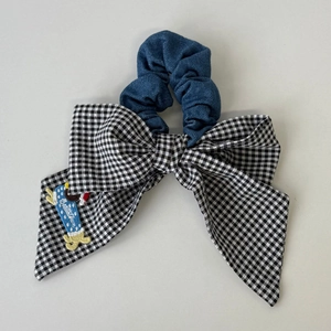 Cute black and white plaid bow scrunchie with denim fabric and puppy patch detail