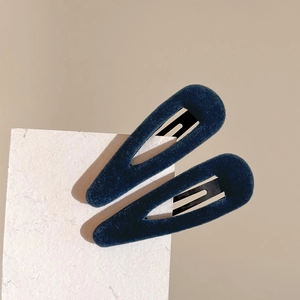Pair of elegant navy blue velvet teardrop BB hair clips on a textured paper card