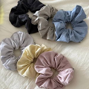 Set of 6 corduroy scrunchies in pastel colors including beige, blue, and rose
