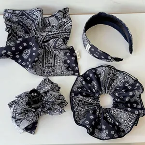Navy blue paisley hair accessory set featuring scrunchie, headband, and ribbon clip