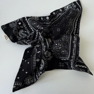 Macro view of navy blue paisley pattern fabric on a handmade bow hair scrunchie