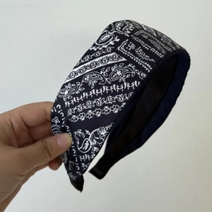 Detail of navy blue paisley fabric headband with classic retro pattern for women