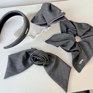 Elegant grey striped fabric hair accessory set including bow scrunchie and rose hair claw