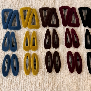 Macro detail of assorted colorful velvet hair clips in geometric shapes for women