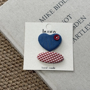 Detail of handmade denim heart hair clip and red gingham BB clip on display card