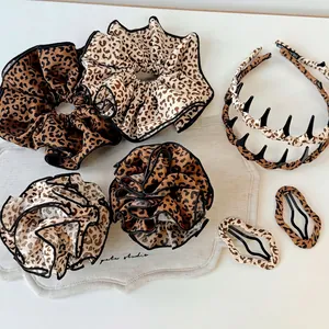 7-piece leopard print hair accessory set with scrunchies, headband, and clips