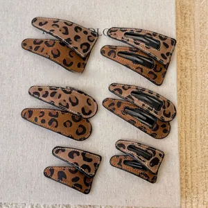 Detail view of 6-piece leopard print faux leather BB hair clips in three different sizes