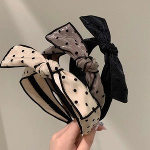 Three-piece set of polka dot bow headbands in beige, taupe, and classic black chiffon fabric