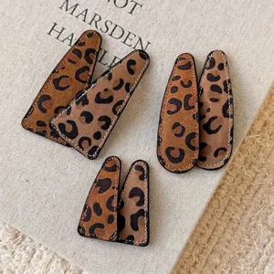 Vintage leopard print hair clips set in brown faux leather with stitched edges