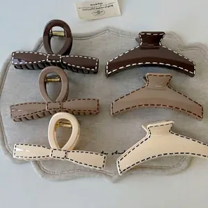 6-piece set of cream brown resin shark hair claws with contrast stitch detail