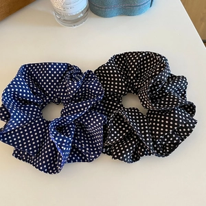 Set of two vintage-style polka dot hair scrunchies in navy blue and black satin fabric