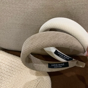 Close-up of retro corduroy sponge headbands in cream and light brown textures